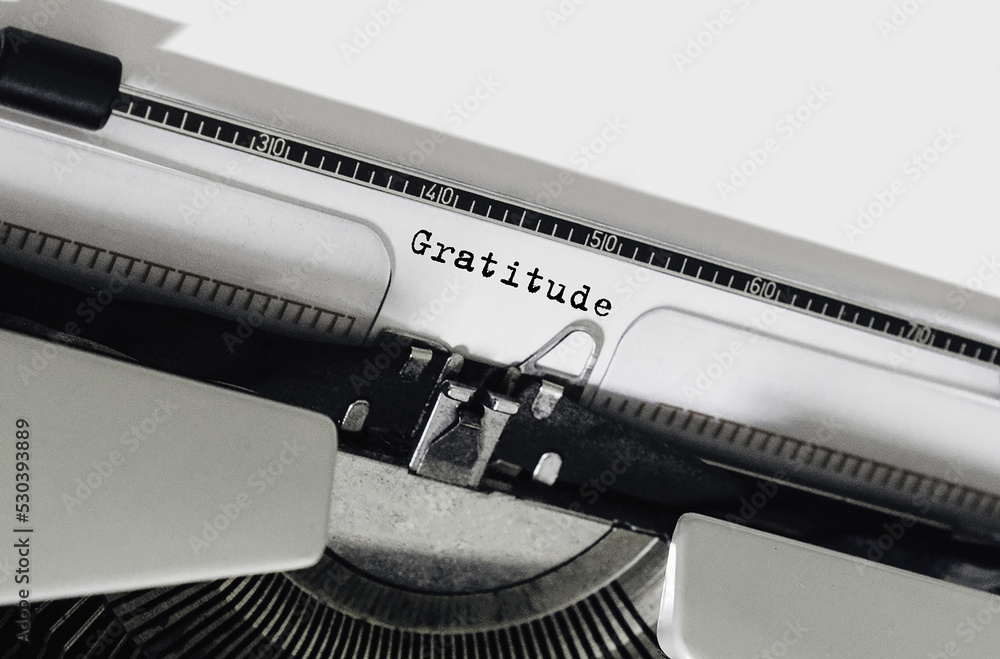 Poster text gratitude typed on retro typewriter