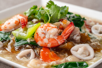 kwetiau siram is Chinese cuisine which is popular in Indonesia, cooked by frying added with complementary vegetables and chicken, seafood or beef meat and thick soup.