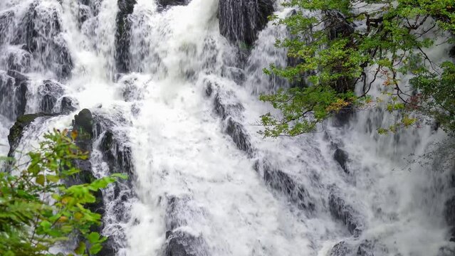 white water cascading over a natural stone Waterfall