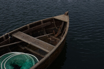 Old fishing boat with a rusty anchor and fishing nets
