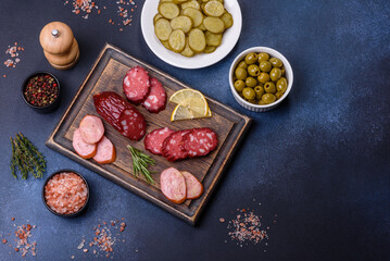 Delicious fresh smoked sausages cut with slices on a wooden cutting board