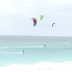 kitesurf, windsurf at sal island, cape verde, light blue sea, beautiful foam in the sea, white sand, fotocard of beach at sal island