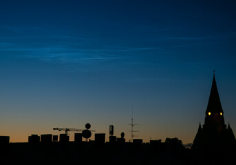 noctilucent clouds over church in the night
