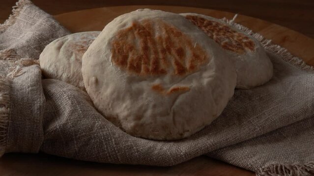 Close-up of Traditional Portuguese flat circular bread Bolo Do Caco on textile background. Madeira island cuisine.