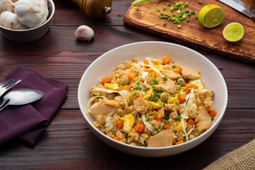 Fried rice with chicken and vegetables in white plate