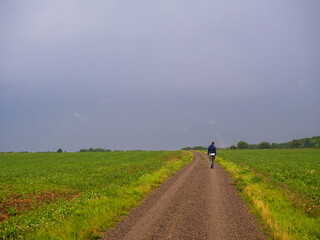 person walking on the road in the countryside