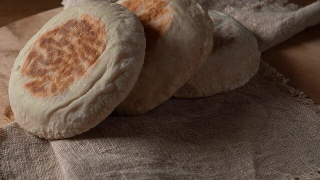 Close-up of Traditional Portuguese flat circular bread Bolo Do Caco on textile background. Madeira island cuisine.