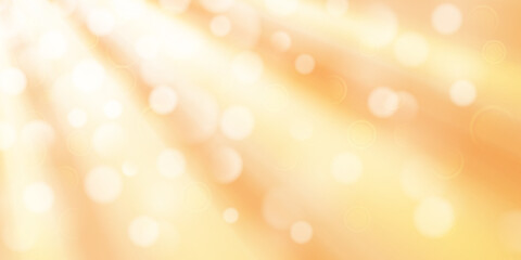 Abstract background in yellow colors with diverging rays of light and small translucent circles with bokeh effect