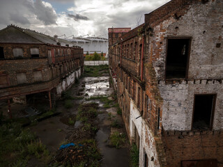 Old generic derelict industrial buildings in a dilapidated state aerial view