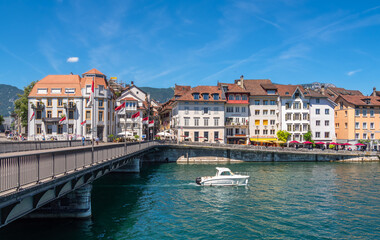 Fototapeta na wymiar Solothurn, Switzerland - July 12, 2022: A boat under the bridge on the river Aare in Solothurn