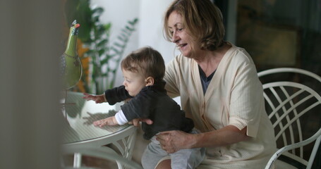 Obraz premium Casual candid grand-mother with grandson baby infant. Grandmother and child relationship