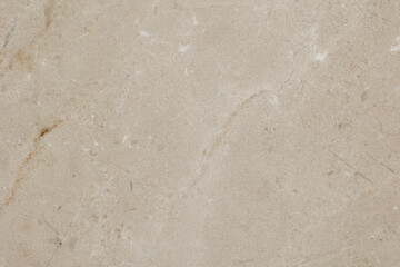 Top view of a natural stone of beige color with brown and white veins used for floor or wall panels