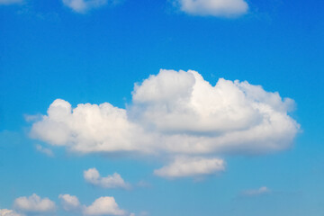 Naklejka na ściany i meble A big curly white cloud in the blue sky