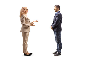 Full length profile shot of a mature woman talking to a young man
