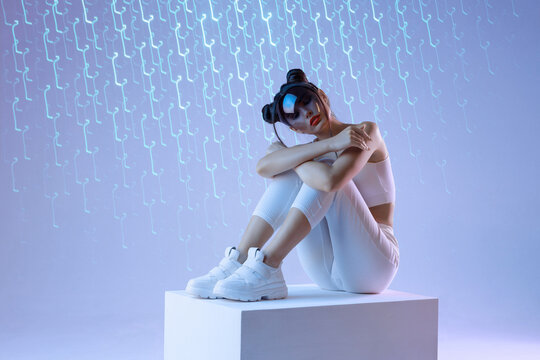 Woman in modern VR glasses interacting with network while having virtual reality experience. Augmented reality game, future technology, AI concept. VR. Holographic interface to display data. - Powered by Adobe