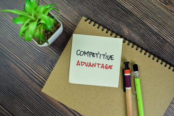 Concept of Competitive Advantage write on sticky notes isolated on Wooden Table.