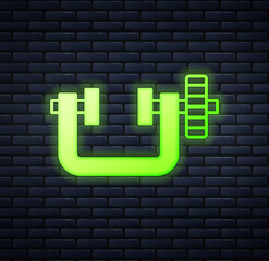 Glowing neon Clamp and screw tool icon isolated on brick wall background. Locksmith tool. Vector