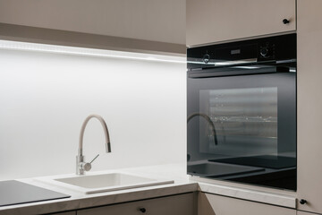 Black built-in oven and sink in kitchen