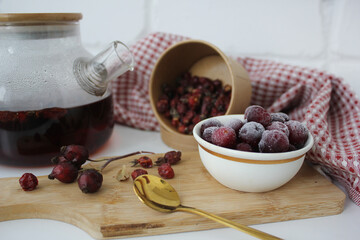 useful vitamin strong black tea in a transparent teapot. herbal tea in autumn
