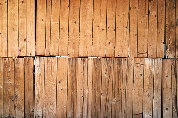 Wooden fence made of raw boards in two parts. High quality photo