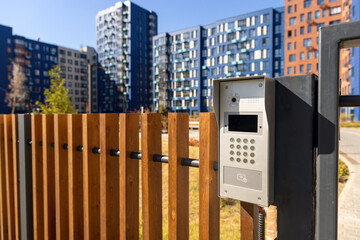 Electronic lock with buttons and intercom on the fence gate, safety device.	