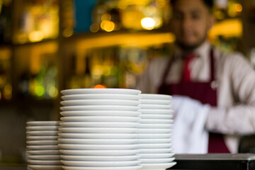 Photography of Barman with dishes in bar with selective focus