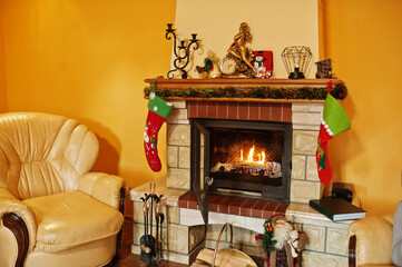 Home fireplace in warm living room on winter day.