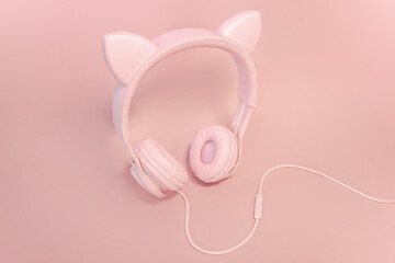 Pink headphones with cat ears on a pink background