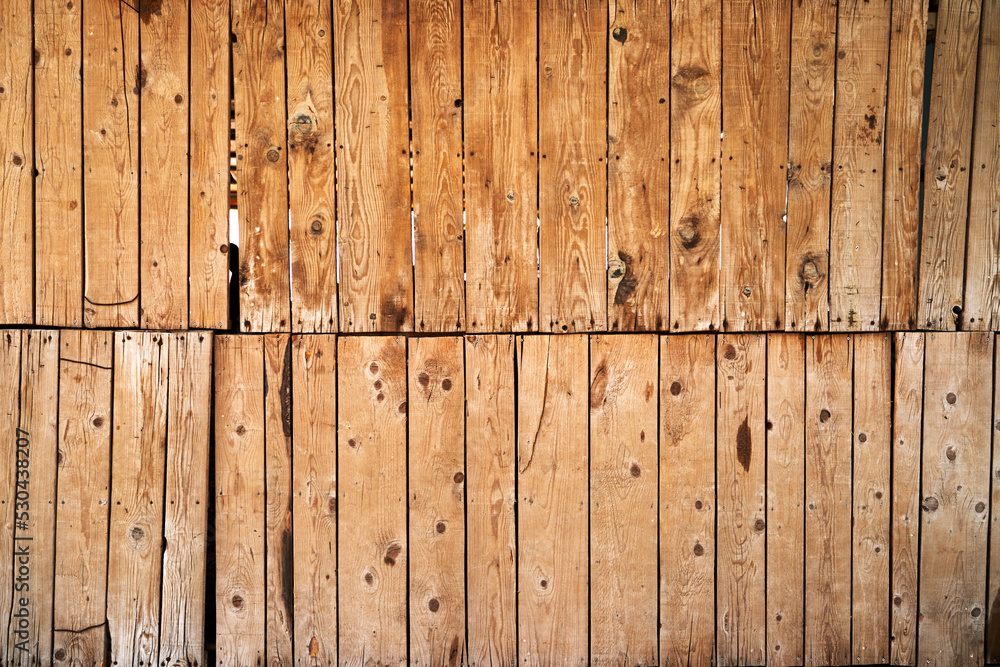 Wall mural structure of a wooden fence from two halves. high quality photo