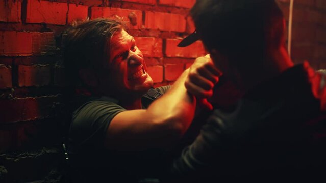 Cinematic movie scene playback for tv screens. Two characters fight using a knife in a dark room and a police agent who is watching the fight. Action movie scene fight playback scene 1.