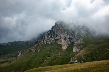 Fototapeta na wymiar Mountain peak hidden under the clouds