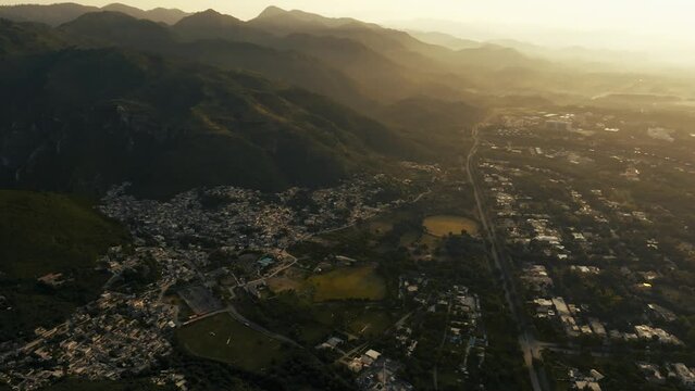 Drone flights forward tilting camera up and revealing amazing hill during sunrise, beautiful mountain siluetes. Filmed in Margalla Hills Islamabad