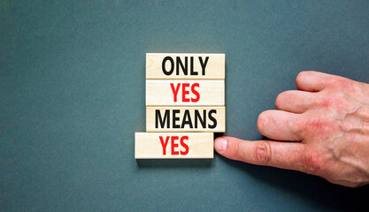 Only yes means yes symbol. Concept words Only yes means yes on wooden blocks on a beautiful grey table grey background. Businessman hand. Business, psychological only yes means yes concept.