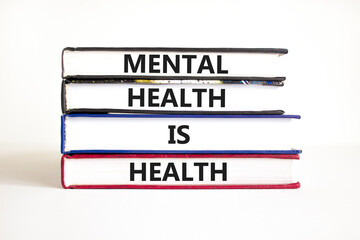 Mental health psychological symbol. Concept words Mental health is health on books on a beautiful...