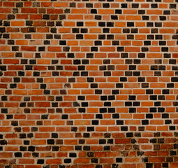Decorative diamond pattern brickwork. Brick wall with diagonal pattern. Old patterned brick wall....