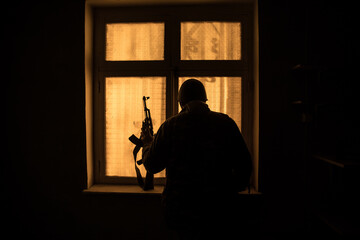 Conceptual photo of war between Russia and Ukraine. Ukraine and Russia flags on windowsill at...