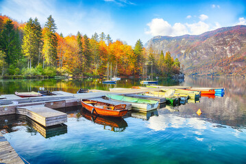 Amazing  view  of  Bohinj Lake with boats during autumn .
