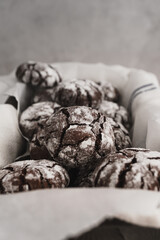 Food photo of freshly baked Chocolate Crinkle Cookies. Portrait orientation image of chocolate...