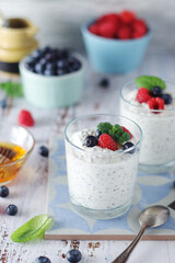 Greek yogurt in glasses with berries and quinoa