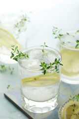 Glasses with lemon and thyme refreshing drink
