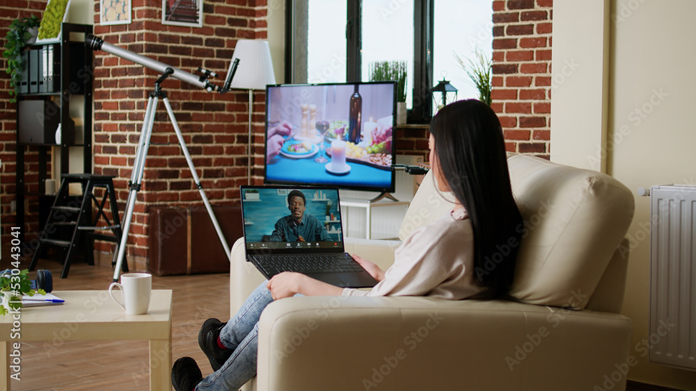 Aufkleber asian woman discussing with coworker on internet conference while doing remote work. office employee