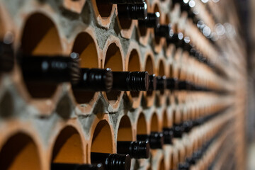 Archive of red wine with black corks in the wine cellar in special brick openings. Bela Krajina,...