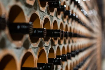 Foto op Aluminium Archive of red wine with black corks in the wine cellar in special brick openings. Bela Krajina, Slovenia © HNstock