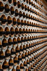 Wine cellar of red wine with black bottles archived in rows. Bela Krajina, Slovenia