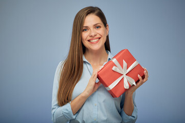 Happy woman holding gift box. Isolated female portrait.