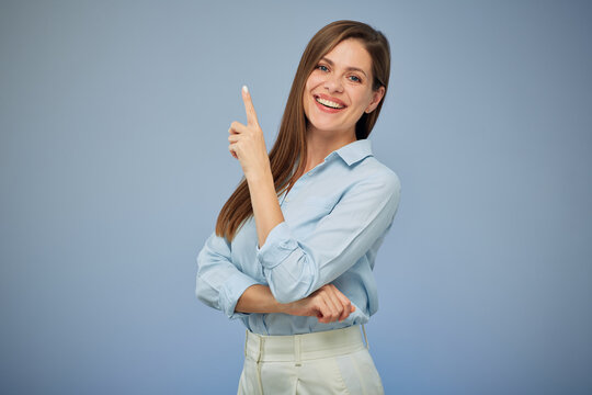 Happy business woman pointing finger up. Isolated portrait female business person.