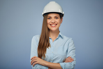 Woman architect or engineer in safety helmet standing with arms crossed. Isolated female portrait.