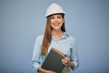 University engineering student wearing protective industrial helmet with a book in her hand. Isolated female portrait.. Isolated female portrait. - Powered by Adobe
