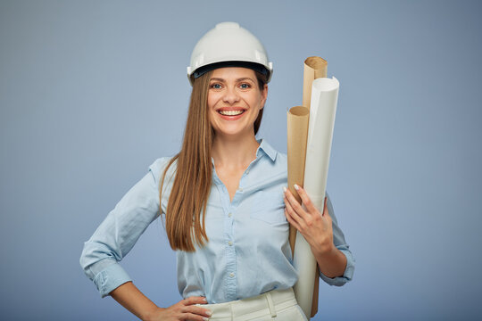 Woman architect in white safety helmet holding blueprints. Isolated female portrait.
