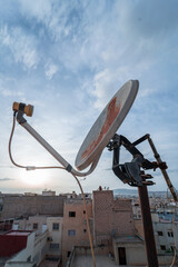 TV satellite dish with sunset sky in the background